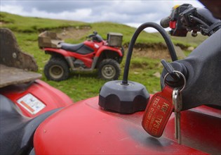 Close-up of the keys in the Honda quad bike on the farm
