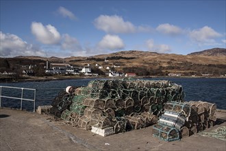 Lobster pots on the Jura Pier with Jura Hotel and whisky distillery behind it