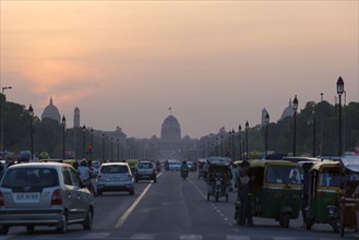 View of road with traffic and government buildings at dusk