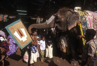 A Vaishnavite devotee blessed by a temple elephant during Chithirai or Chitra festival in Madurai