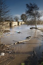 River flooding with high water levels under bridge