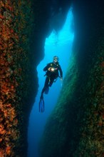 Diver in narrow crevice