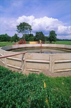 Concrete-sided slurry lagoon on the farm