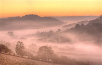 View of mist and frost in valley at sunrise