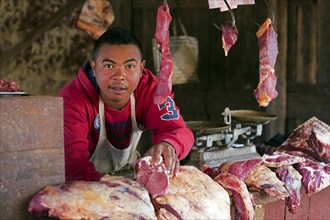 Malagasy butcher selling meat in an open-air butchery in the streets of Ambalavao town