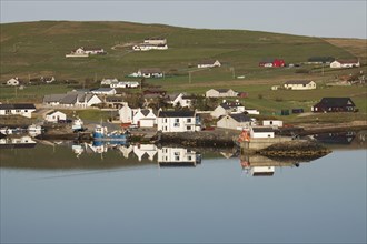 View of a coastal village reflected in the sea