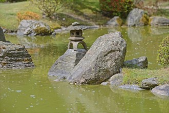 Typical Japanese garden with stone decorations