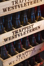 Stacked wooden beer crates with Trappist Westvleteren bottles