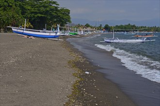 Traditional outrigger boats on the black lava beach