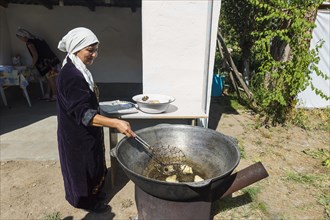 Kazakh woman preparing traditional local tandyr bread