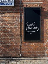 Slate plaque on the brick wall of a restaurant