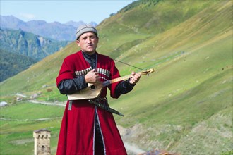 Georgian musician of a folklore group playing panduri