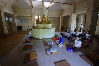 Believers meditate in prayer room
