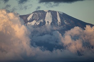 View of mountain summit with clouds at sunset