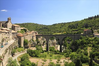 View of historic town with bridge over river valley