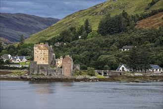 Eilean Donan Castle in Loch Duich and the visitor centre seen from Totaig