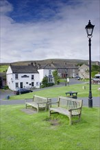 Village green with benches and lamppost