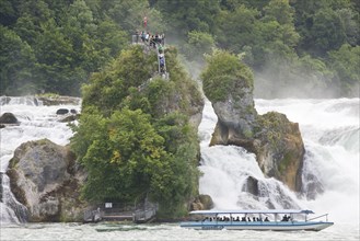 Tourist boat and visitors at the largest shallow waterfall in Europe