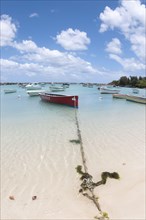 Boats moored on the sandy beach