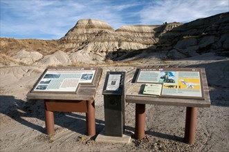 Dinosaur information boards in badlands habitat