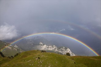 View of double rainbow over mountain landscape