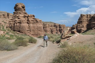 Man walking on the road in Sharyn Canyon National Park and Valley of Castles