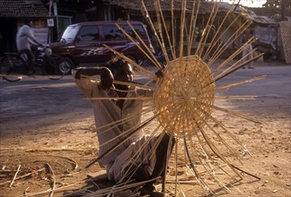 A man weaving bamboo strips baskets at Lawley Road in Coimbatore