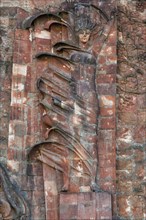 Close-up of communist-era faces on the facade of the city market