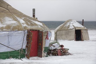 Yurts in the traditional Kyrgyz yurt camp during a snowstorm at Song-Kul Lake
