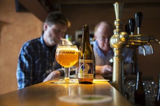 Tripel Sint-Canarus beer by the glass and bottle on the bar at the cafe in Gottem