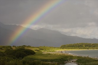 View of rainbow over coastal habitat