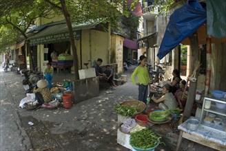 Woman selling vegetables on the street in the city