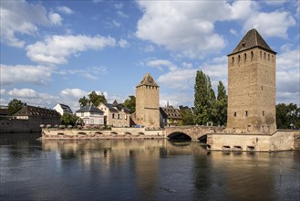 Towers of the medieval bridge Ponts Couverts over the river Ill in the Petite France district of the city of Strasbourg