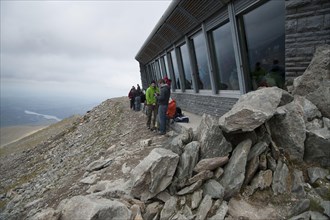 Hafod Eryri visitor centre and walkers on mountain summit