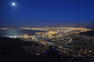 View of coastal city at night
