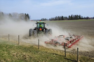 John Deere tractor pulling Vaderstad cultivator