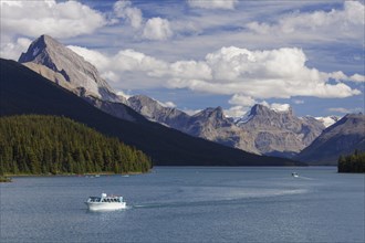 Canoes and tourist boat on Maligne Lake in Jasper National Park