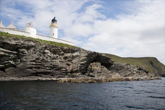 View of sea cliffs and lighthouse