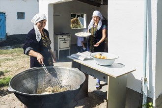 Kazakh woman preparing traditional local tandyr bread