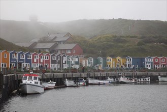 Coastal houses and boats in fog