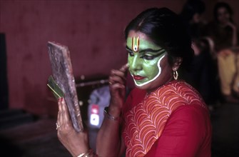 A Seethankan or Sheethankan thullal artist applying makeup in Kerala Kalamandalam at Cheruthuruthy