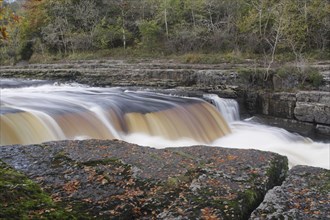 View of river flowing over limestone cliffs