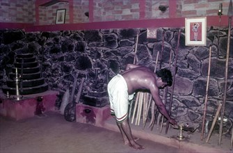 A man worshipping oil lamp in Kalaripayattu training centre in Thiruvananthapuram