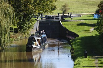 Narrow boat leaving canal lock