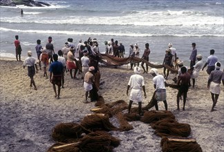 Fishermen hauling the fishing nets in Kovalam beach near Thiruvananthapuram