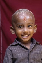 South Asia Indian boy smiling after his tonsure ceremony