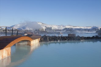 Tourists bathing in the blue lagoon rich in minerals such as silica and sulphur in a lava field in winter