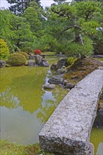 Typical Japanese garden with stone decorations and koi pond