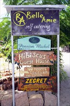 Sign indicating hotels and guesthouses on the island of La Digue