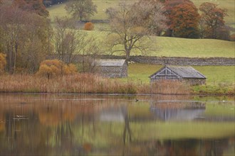 View of boathouse beside lake in autumn